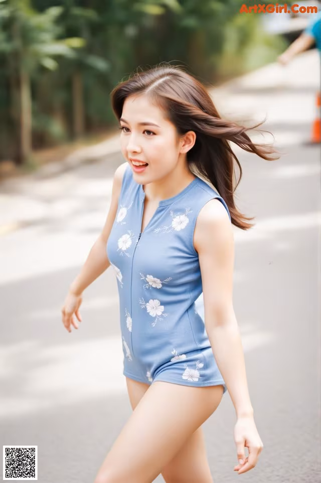 A woman in a blue romper is walking down the street.