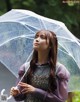 A woman holding an umbrella in the rain. 